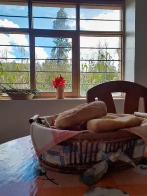 a basket sitting on a table in front of a window at Pisonaywasi - Hospedaje familiar in Urubamba
