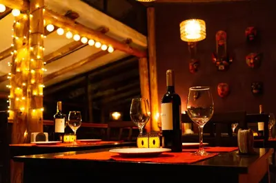 a table with wine bottles and glasses on it at Casa de La Chola in Ollantaytambo