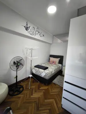 a bedroom with a bed and a floor fan at Lindo apartmento en PLAZA PRINCIPAL in Lima