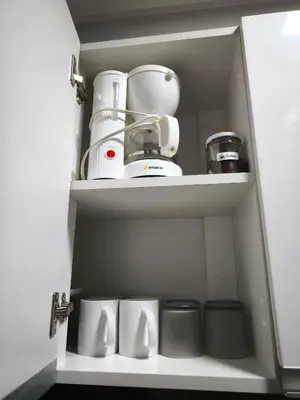 a kitchen cupboard with some appliances in it at Lindo apartmento en PLAZA PRINCIPAL in Lima