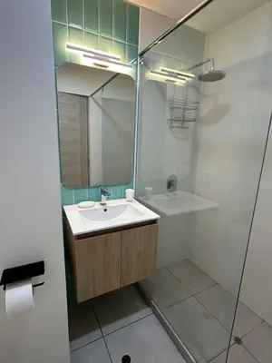 a bathroom with a sink and a shower with a mirror at No available in Lima