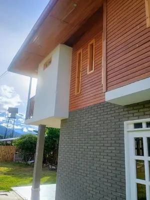 a house with a balcony on the side of it at Edelweisshaus Chontabamba in Oxapampa