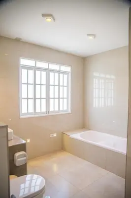 a bathroom with a bath tub and a window at Edelweisshaus Chontabamba in Oxapampa