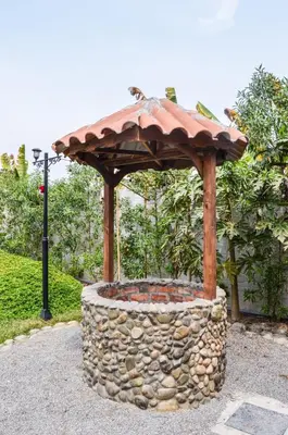 a stone fire pit with a roof on top of it at Villa Aurora in Aucallama