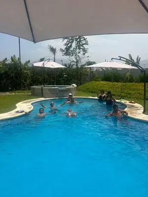 a group of people in a swimming pool at Villa Aurora in Aucallama