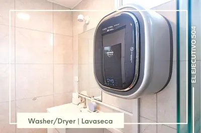 a bathroom with a sink and a soap dispenser on the wall at Vibrant Exclusive 1BR Apt in front of Casa Andina in Lima
