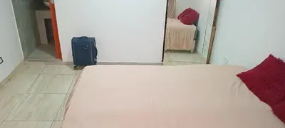 a bedroom with a bed and a suitcase in a room at Colibri in Lima