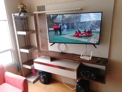 a flat screen tv hanging on a wall in a living room at Alquilo Departamento en Comas in Lima
