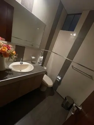 a bathroom with a sink and a toilet and a mirror at Casa Huertos CIENEGUILLA in Cieneguilla