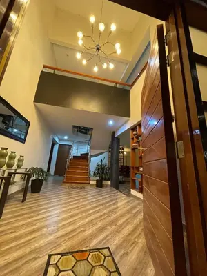 a large lobby with a staircase and a chandelier at Casa Huertos CIENEGUILLA in Cieneguilla