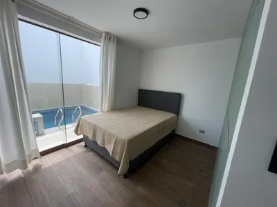 a bedroom with a bed and a large window at Casa de campo en condo cerca a playa Puerto Viejo in San Antonio