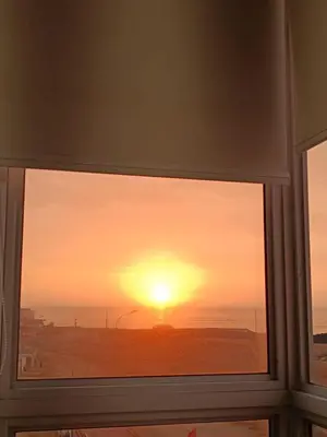 a window with a view of the sunset at Rosita del Mar in San Bartolo