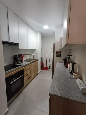 a kitchen with white cabinets and a counter top at Rosita del Mar in San Bartolo