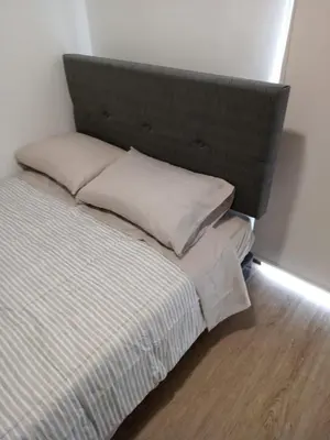 a bed with two pillows on it in a room at Rosita del Mar in San Bartolo