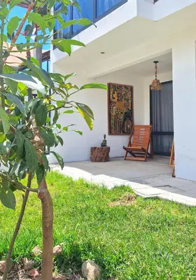 a porch of a house with a bench and a painting at Casa Qiru tu Refugio en Oxapampa in Oxapampa