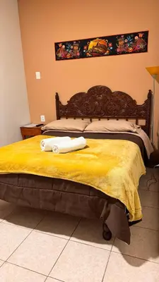 a bed with two towels sitting on top of it at Templo de la Luna Pardo in Cusco