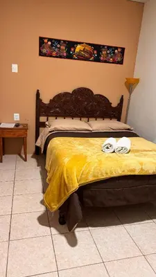 a bedroom with a bed with two towels on it at Templo de la Luna Pardo in Cusco