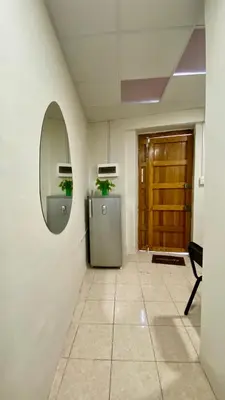 a hallway with a mirror and a refrigerator in a room at Templo de la Luna Pardo in Cusco