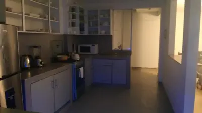 a kitchen with blue cabinets and a microwave at Casa EN ASIA in Asia