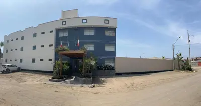 a blue and white building with plants in front of it at Boulevard Hotel in Asia