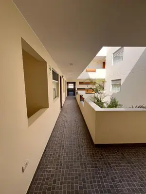 an empty hallway of an office building with plants at Boulevard Hotel in Asia