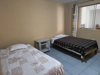a bedroom with two beds and a window at Dpto Familiar en San Bartolo in San Bartolo