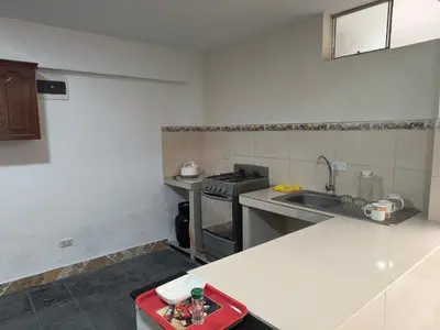 a kitchen with a sink and a stove at Dpto Familiar en San Bartolo in San Bartolo