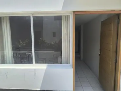 an empty room with a window and a door at Dpto Familiar en San Bartolo in San Bartolo
