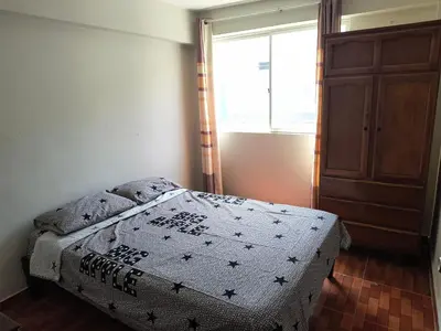a bedroom with a bed in a room with a window at Dpto Familiar en San Bartolo in San Bartolo
