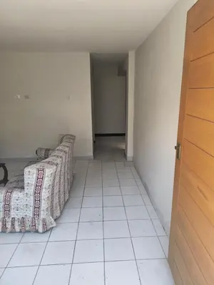 a room with two beds sitting on a tiled floor at Dpto Familiar en San Bartolo in San Bartolo