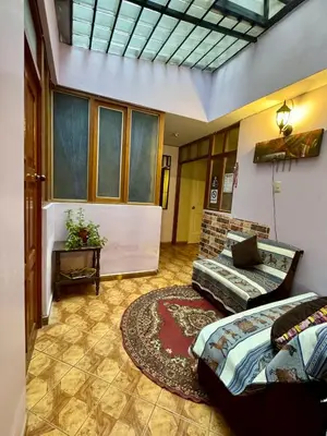 a living room with a bed and a couch at Tika house in Cusco