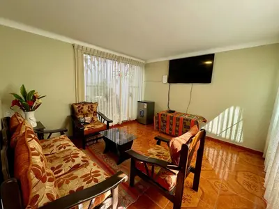 a living room with a couch and a table at Tika house in Cusco