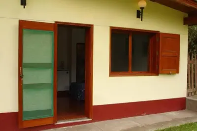a house with two glass doors and a window at Swiss Chalet en Canta in San Miguel