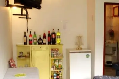 a kitchen with a refrigerator and a lot of bottles at Swiss Chalet en Canta in San Miguel
