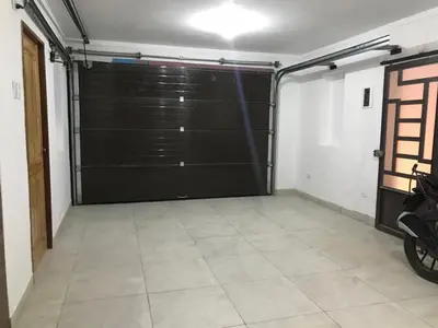 a garage with a large black garage door at Albano apartamento 3 en tu refugio Chosica in Chosica