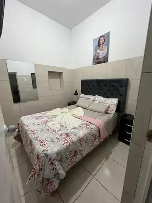 a bedroom with a bed with a pink and white blanket at Albano apartamento 3 en tu refugio Chosica in Chosica