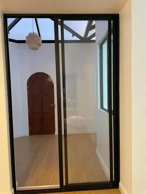 a sliding glass door in a room with a doorway at Habitaciones casa Bella in Lima
