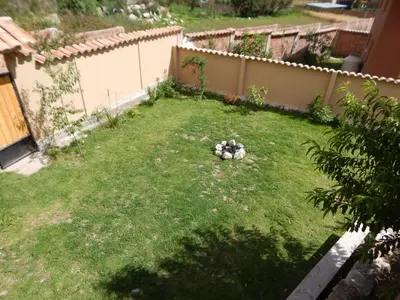 a yard with a pile of rocks in the grass at Casa Higospampa, 2 Floors Up to 7 Residents in Urubamba