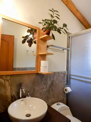 a bathroom with a sink and a mirror and a toilet at Casa Higospampa, 2 Floors Up to 7 Residents in Urubamba