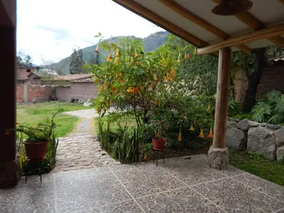 an outdoor patio with a tree with oranges on it at Casa Higospampa, 2 Floors Up to 7 Residents in Urubamba