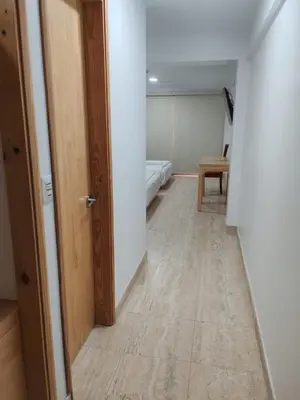 an empty hallway with a room with a bed and a door at Hotel Boutique La Angostura II in Ica