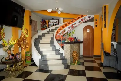 a staircase in a living room with a checkered floor at Hostal Luren - Parking in Nazca