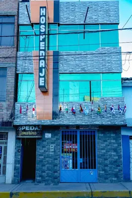 a building with a sign on the front of it at Hospedaje Samarina in Acobamba