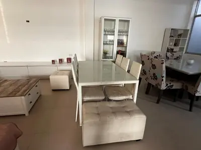 a glass table and chairs in a living room at Tanaka Beach House in Tanaca