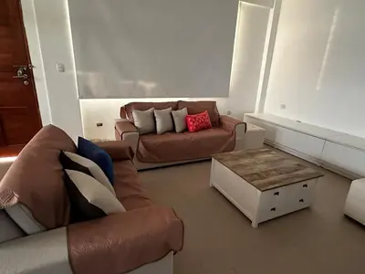 a living room with a couch and a coffee table at Tanaka Beach House in Tanaca