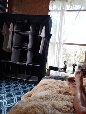 a person laying on a bed in a bedroom at Bugambilia house in La Tinguiña