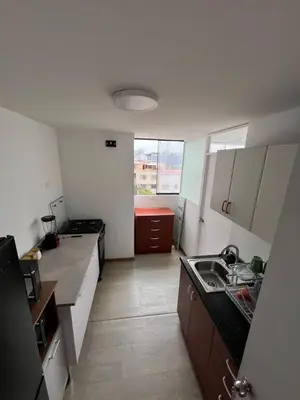 a small kitchen with a sink and a counter at Departamento Prescott in Lima
