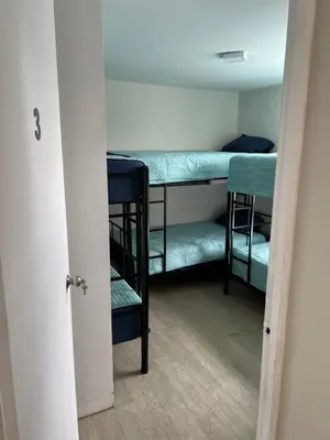 a room with three bunk beds in a room at Departamento Prescott in Lima