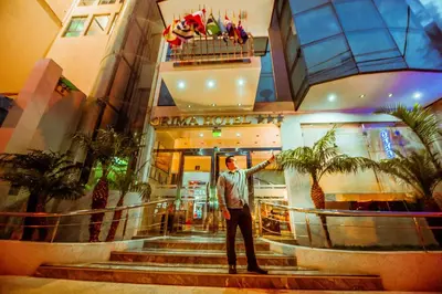 a man standing in front of a building at Grima Hotel in Huánuco