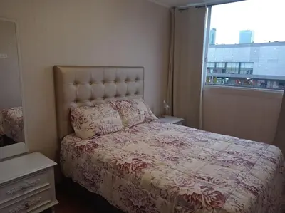 a bedroom with a bed with a large window at Departamento en Santa Catalina in Lima